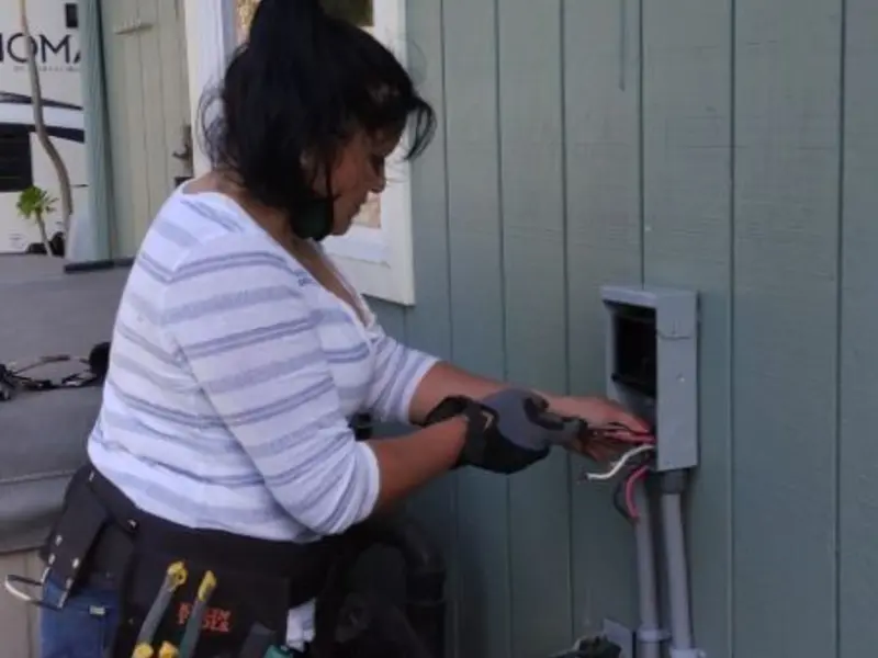 Licensed electrician wiring an exterior subpanel in Oregon